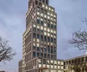 INCUBA Next skyscraper in Aarhus, Denmark - the glazed facade is covered by an openwork structure of light-colored bricks