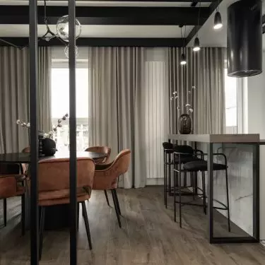 The dining room and kitchen are right next to the staircase