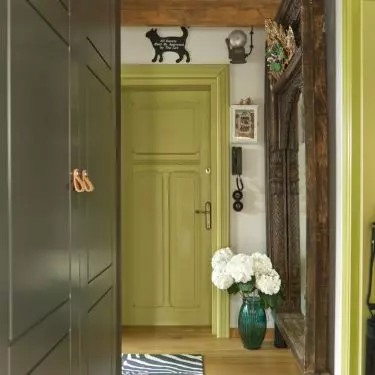 Windows and doors throughout the apartment have a luscious green hue
