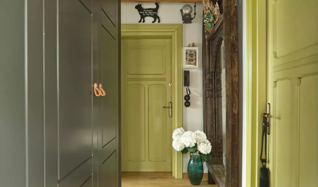 Windows and doors throughout the apartment have a luscious green hue
