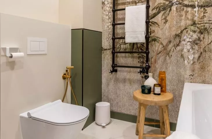 Decorative black radiator hangs on wall with wallpaper