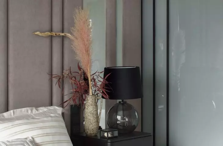 Black bedside tables break up the light color scheme