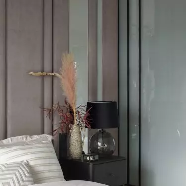 Black bedside tables break up the light color scheme