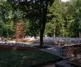 Between the embankments, at the central point of a small square, the architects designed a vertical dominant