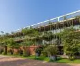 Health and relaxation center in Cambodia - the complex consists of five rows of houses, with a row of additional buildings perpendicularly aligned to them, forming a unified façade that acts as a facade wall