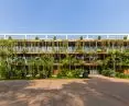 Health and relaxation center in Cambodia - the regular lines of the metal facade will gradually be complemented by tropical vegetation