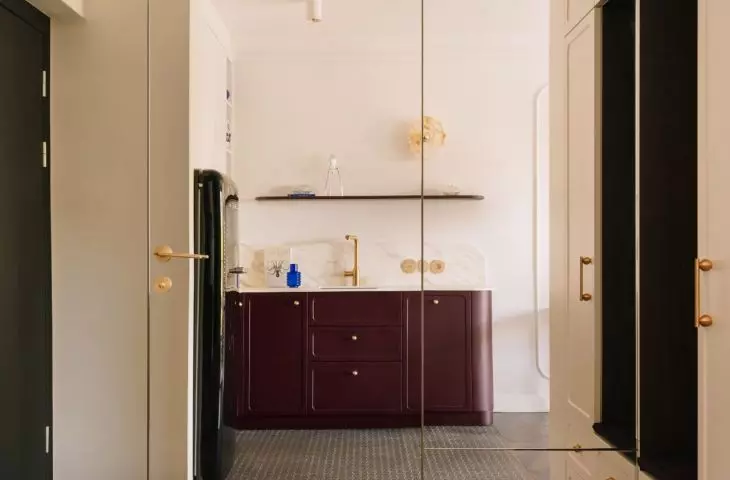 Bathroom door hidden behind a mirrored wall 