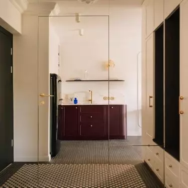 Bathroom door hidden behind a mirrored wall