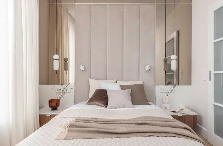 The wall behind the bed was soundproofed and lined with an upholstered panel