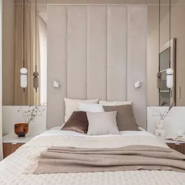 The wall behind the bed was soundproofed and lined with an upholstered panel