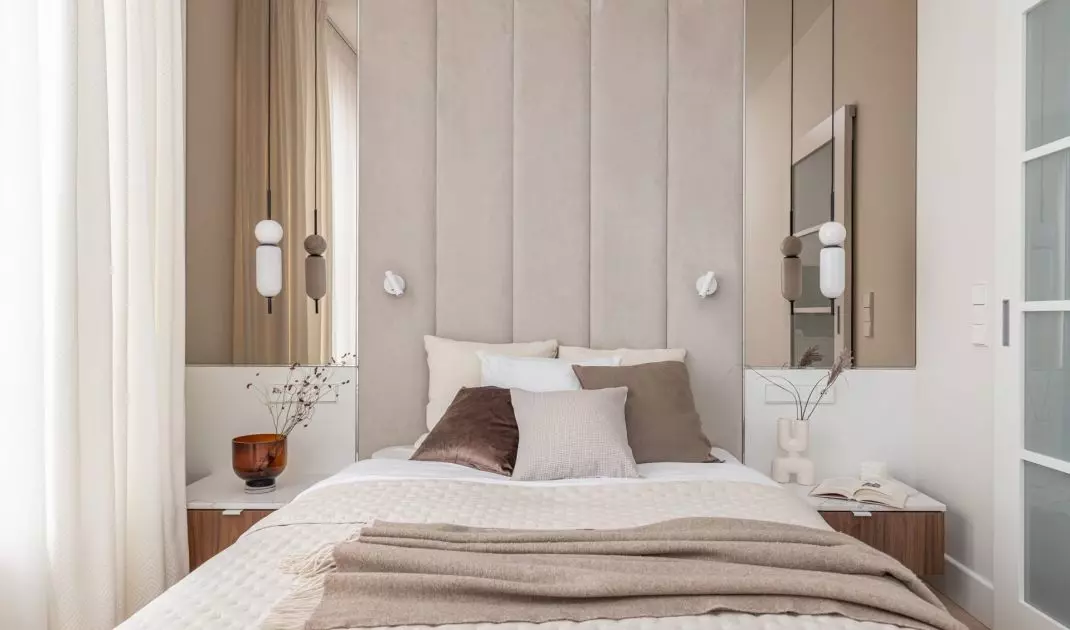 The wall behind the bed was soundproofed and lined with an upholstered panel