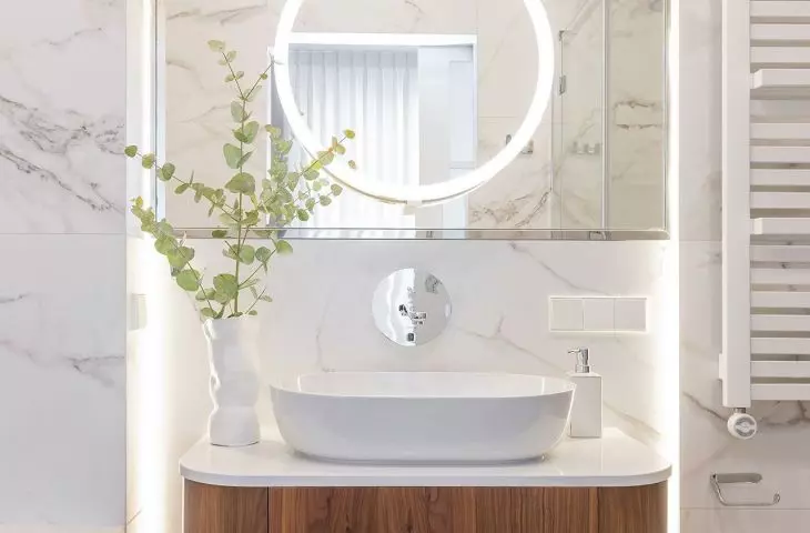 A smaller mirror with illumination slides out of the large mirror