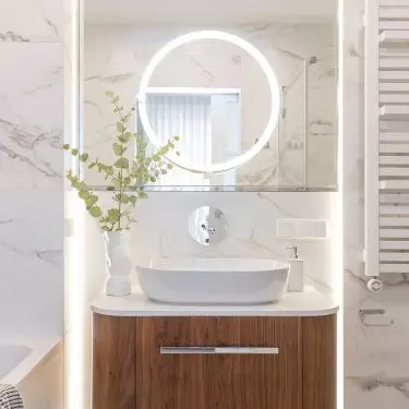 A smaller mirror with illumination slides out of the large mirror