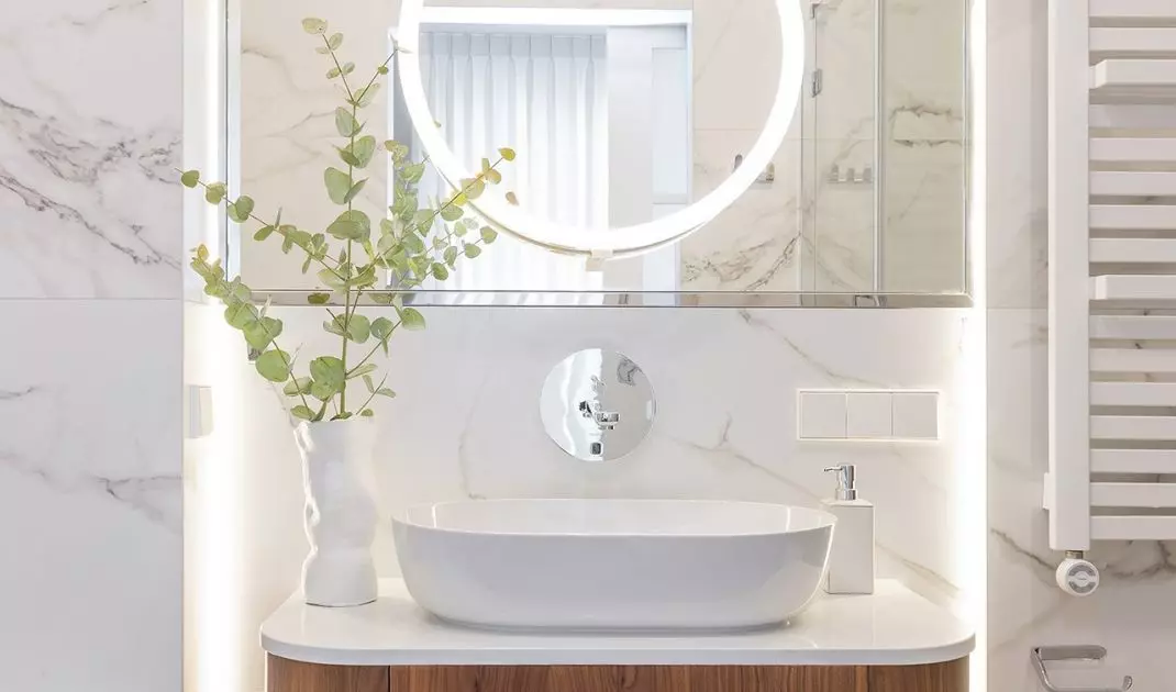 A smaller mirror with illumination slides out of the large mirror