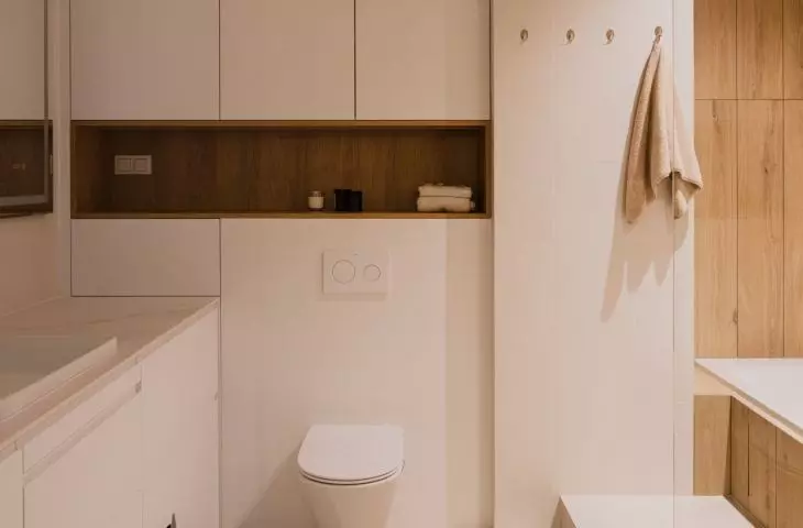 The bathroom is also kept in white and wood