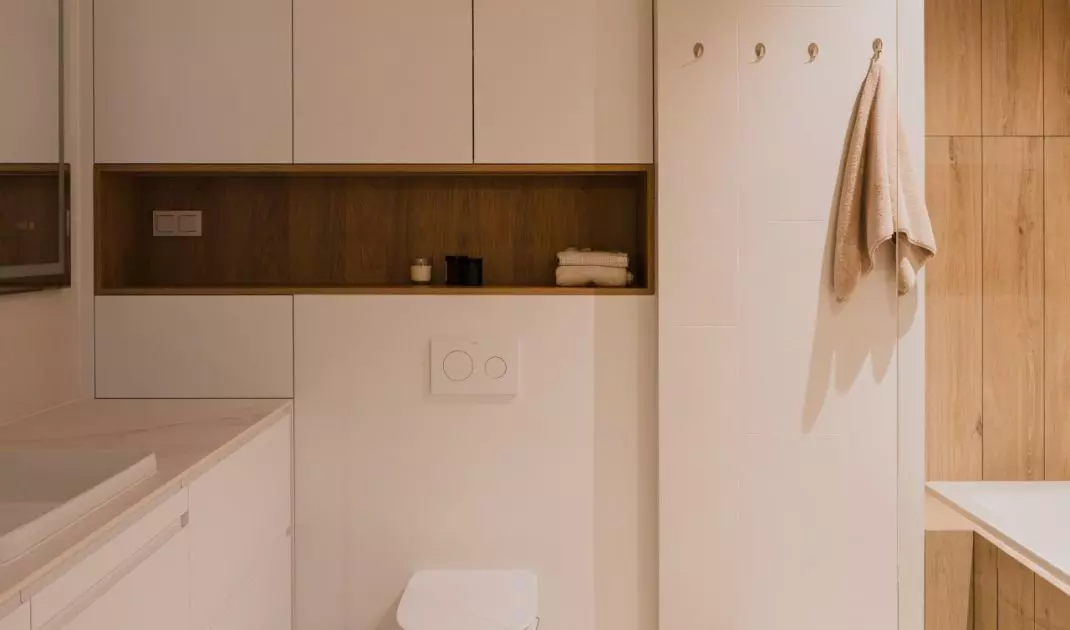 The bathroom is also kept in white and wood