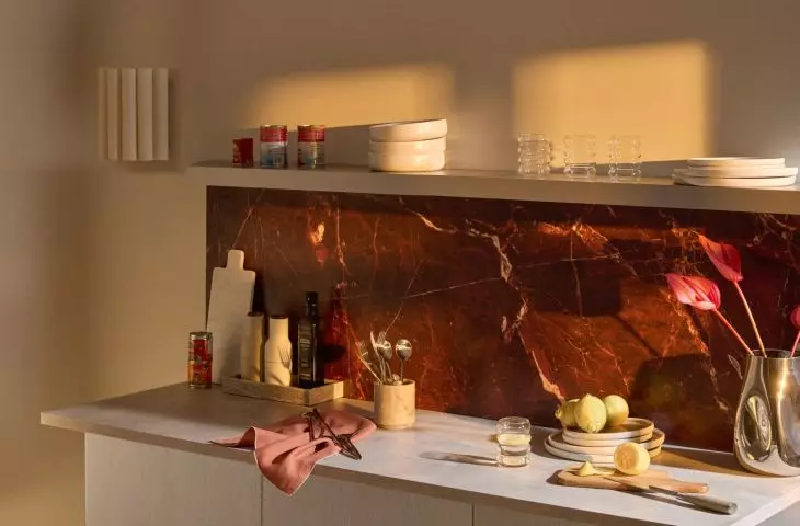 The wall above the countertop decorated with contrasting marble will create an intriguing kitchen design