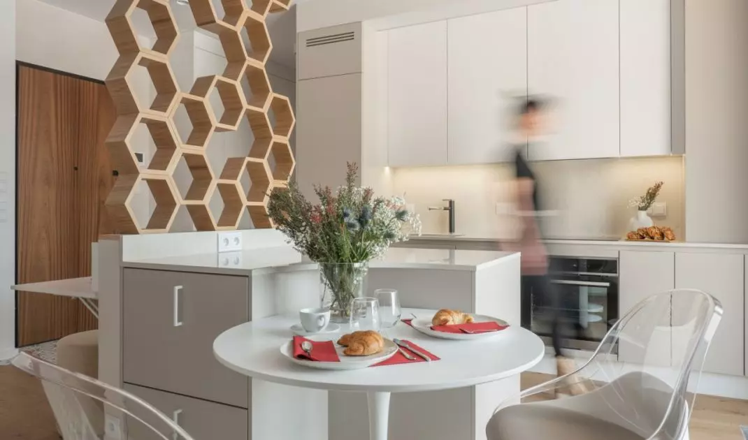 Hexagonal wall separates workspace from kitchen
