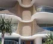 Norfolk residential building in Gold Coast, Queensland, Australia - the centerpiece of the facade is horizontal laths with gentle curves, acting as a sunshade in the warmer months