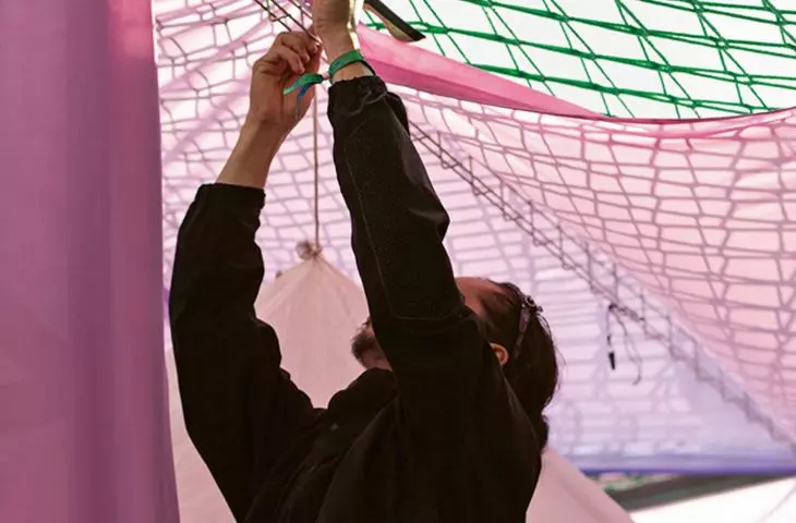 industrial warehouse racks, tarpaulins and nets used for scaffolding were used to build 