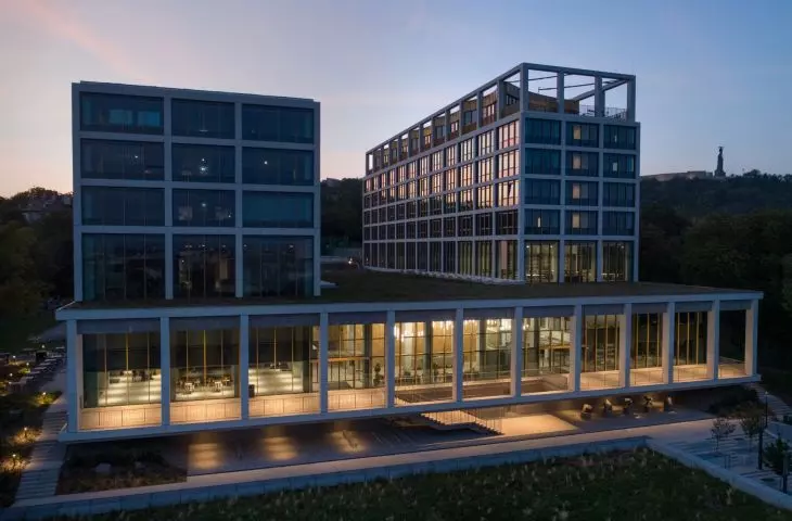 Corvinus Gellért campus in Budapest - two towers that emerge from the terraced body of the building balance the wide, horizontal mass of the structure
