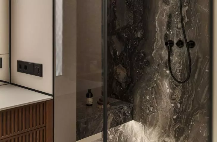 The stone used in the shower room relates to the kitchen design