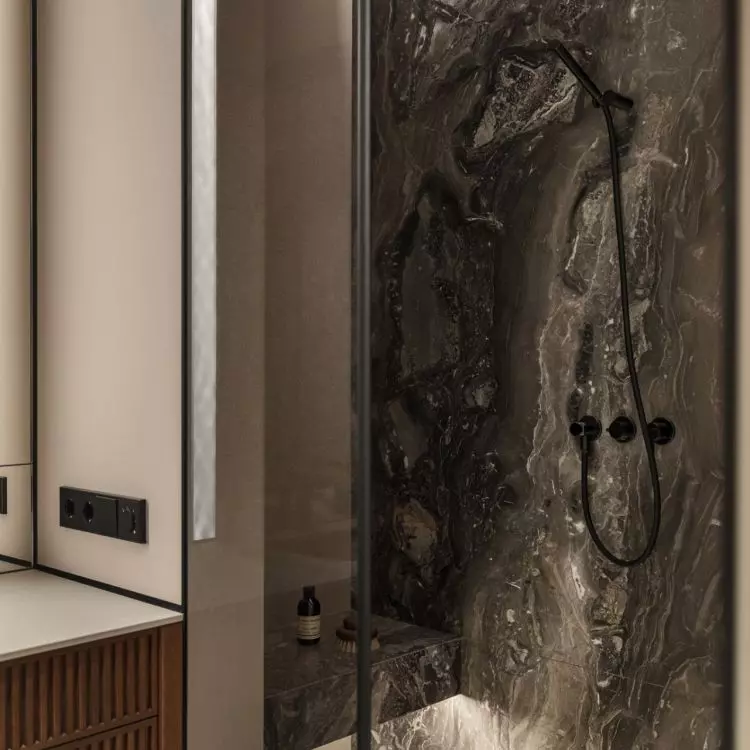The stone used in the shower room relates to the kitchen design