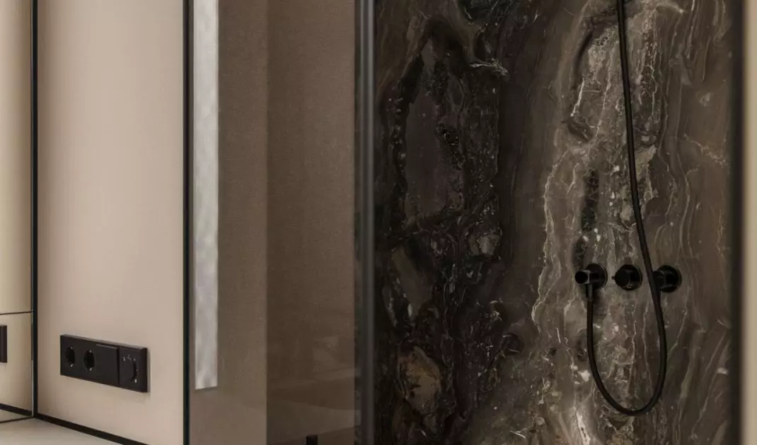 The stone used in the shower room relates to the kitchen design