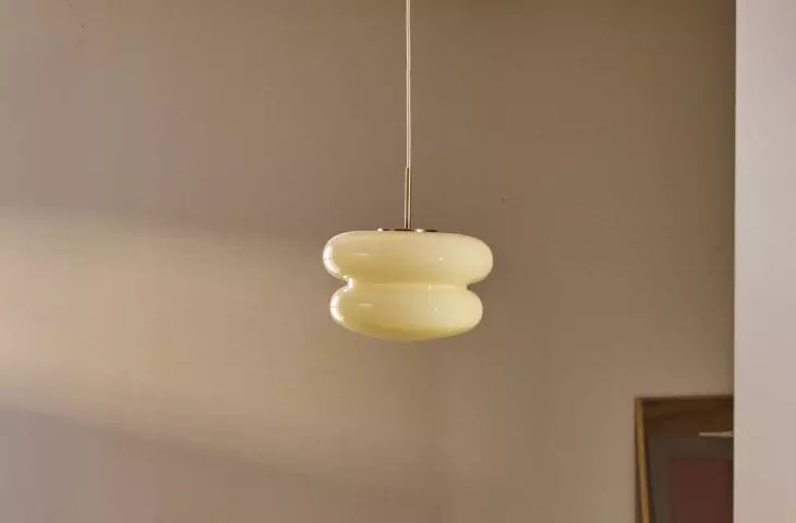 Lamp in butter yellow shade will add subtle charm to the interior