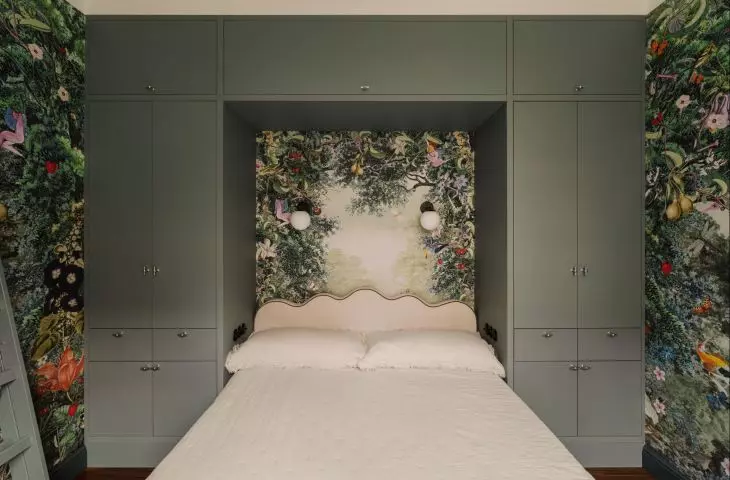 The bedroom walls are covered with a spectacular wallpaper