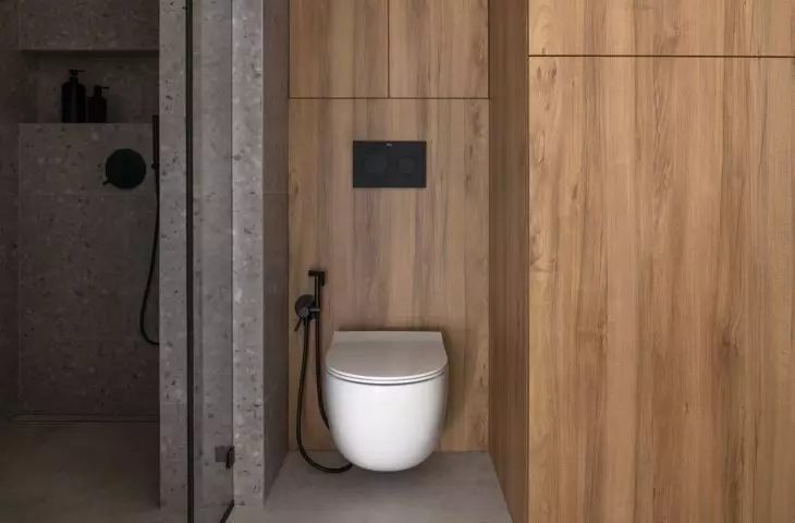 The shower area has been tiled with a terrazzo motif
