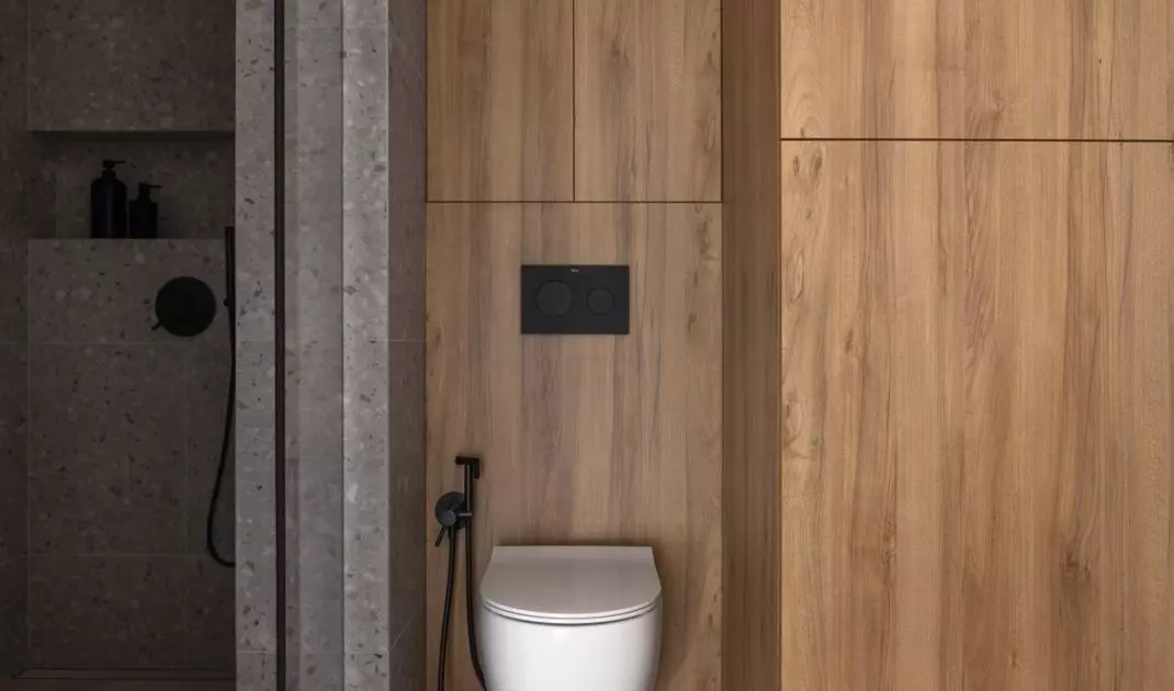 The shower area has been tiled with a terrazzo motif