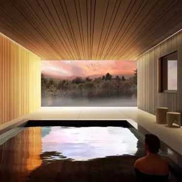 The swimming pool with a glass wall is hidden under the building