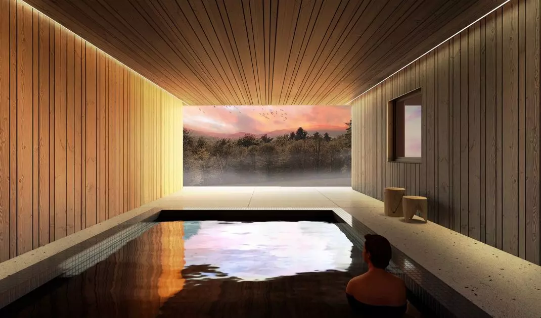 The swimming pool with a glass wall is hidden under the building