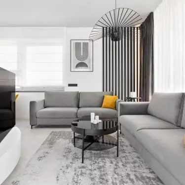 Interior of an apartment in the Baildomb estate in Katowice - living room with gray sofas and yellow pillows