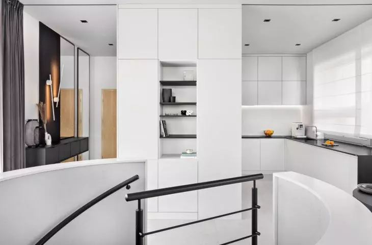 Interior of an apartment in the Baildomb estate in Katowice - view of the kitchen and staircase leading to the private area
