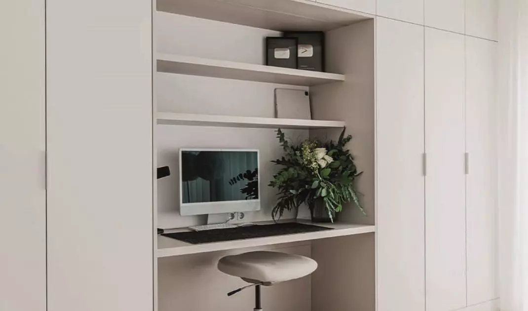 The office has a built-in desk with space for documents