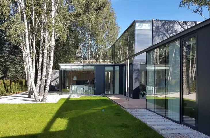 From the garden, the structure resembles a glass pavilion
