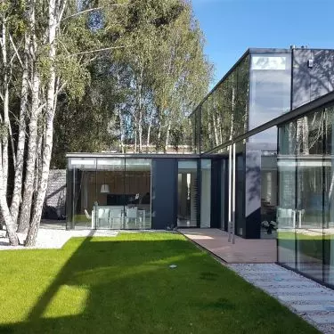From the garden, the structure resembles a glass pavilion