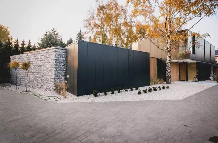 Dark matte facades were juxtaposed with wooden accents and large glazed areas