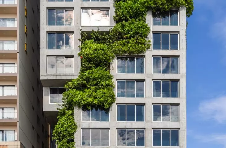 A hotel in Da Nang, Vietnam - the shorter western facade is distinguished by a sculptural structure into which greenery has been woven