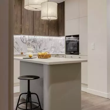 The kitchen island has fashionable rounded edges