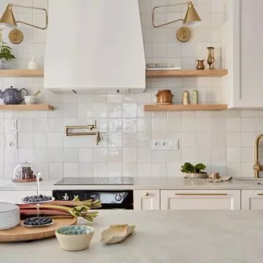 Kitchen island in Letnica apartment becomes the center of the house
