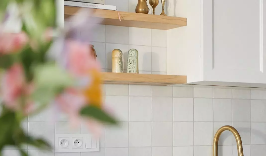 The kitchen is dominated by shades of white and gold