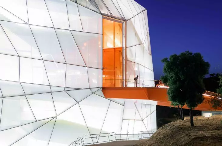 Plasencia conference center - an orange ramp leads inside the building 