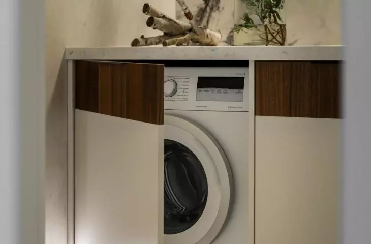 The enclosure hides the washing machine