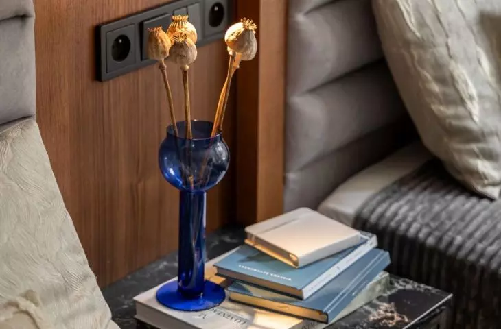 Between the beds there is a bedside table finished with a stone top