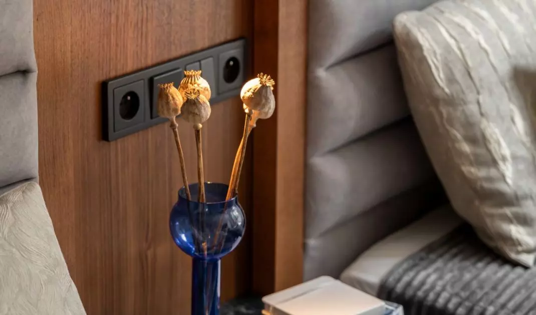 Between the beds there is a bedside table finished with a stone top
