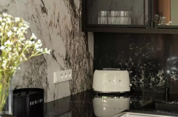 The kitchenette is dominated by a combination of black and white