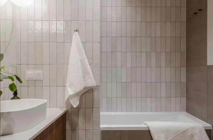 The bathroom is dominated by the colors of brown, beige, gray and white